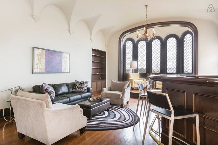 this-living-room-with-a-bar-and-large-bay-window-is-perfect-for-party-hosting