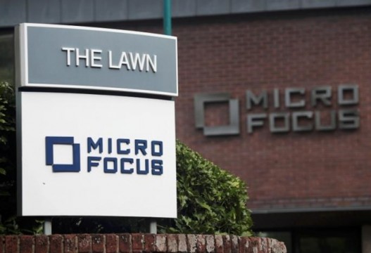 Signs stand outside the offices of Micro Focus in Newbury
