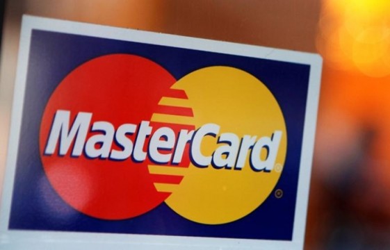A MasterCard logo is seen on a door outside a restaurant in New York