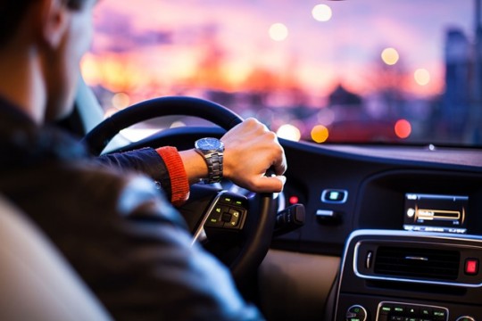 man-driving-in-car-in-the-city-ride-share-uber-lyft-getaround-zipcar