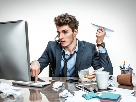 Guy with paper plane typing on a computer