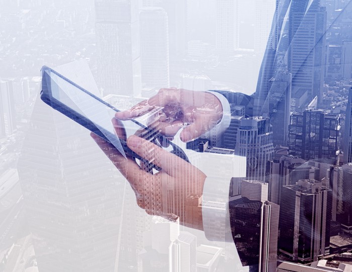Businessman using tablet pc & double exposure