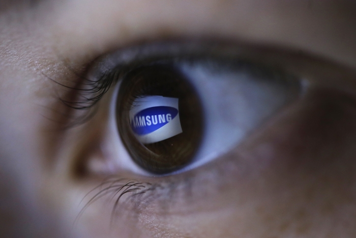 Picture illustration shows Samsung's logo reflected in a person's eye, in central Bosnian town of Zenica