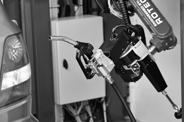 A car-fuelling robot is seen fuelling up a car in Emmeloord